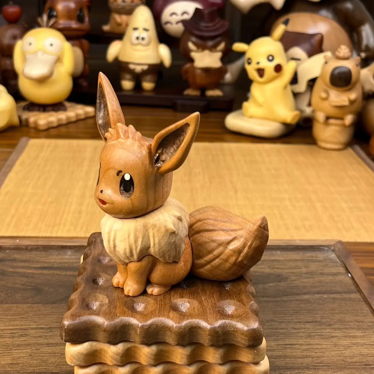 Hand-carved wooden Eevee figurine in sitting pose on a wooden base, detailed craftsmanship