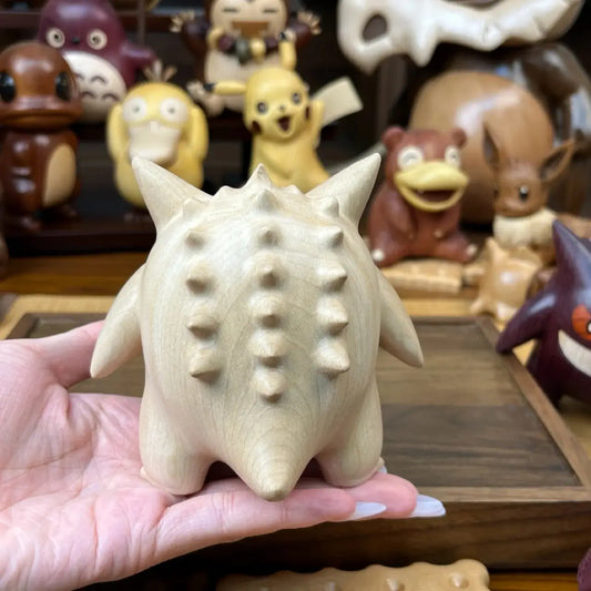 Close-up showing the back spikes of a handcrafted Gengar wooden figure