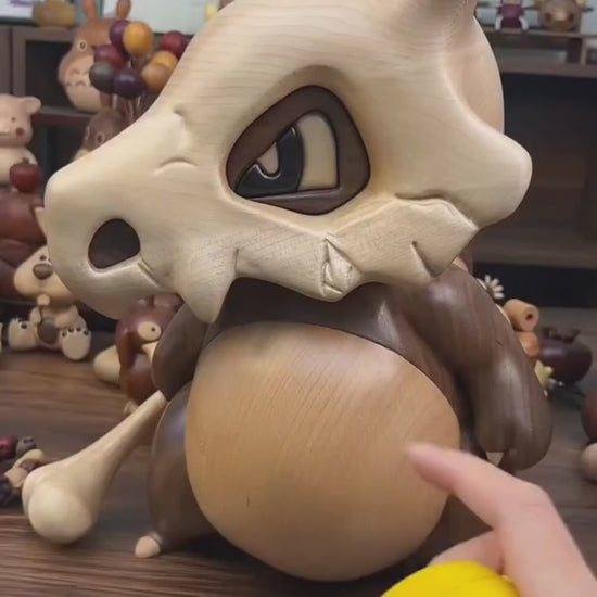 Pokémon merchandise Cubone wood - carved figure, displayed in various scenes, reference for collectors.